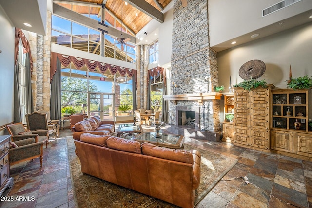 living room with beam ceiling, a fireplace, high vaulted ceiling, and wooden ceiling