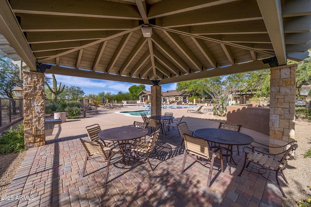 view of patio with a gazebo and a community pool