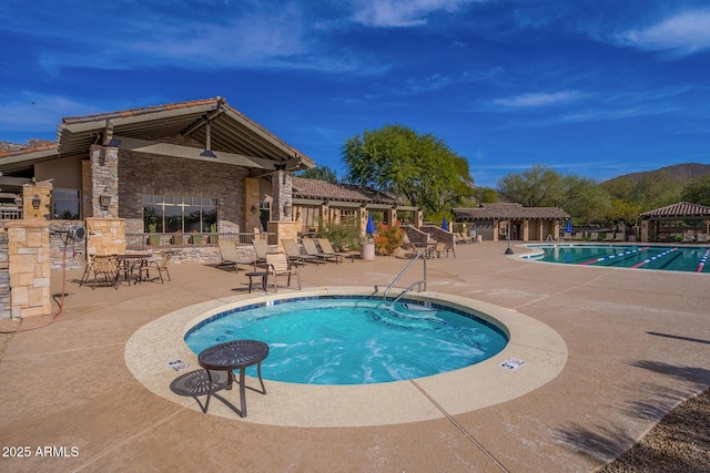 view of swimming pool with a patio and an outbuilding