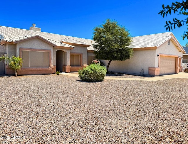 10722 W Quartz Dr, Casa Grande, AZ 85193 - view of front of home featuring a tile roof, a garage, driveway, stucco siding, and a chimney