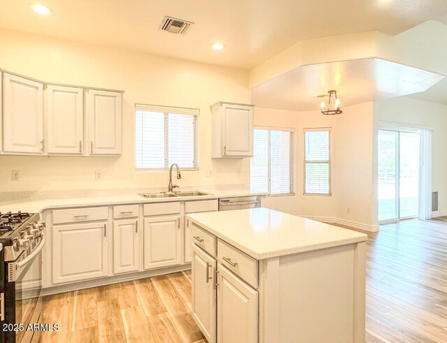10722 W Quartz Dr, Casa Grande, AZ 85193 - kitchen featuring light wood-style floors, appliances with stainless steel finishes, recessed lighting, white cabinetry, and light countertops