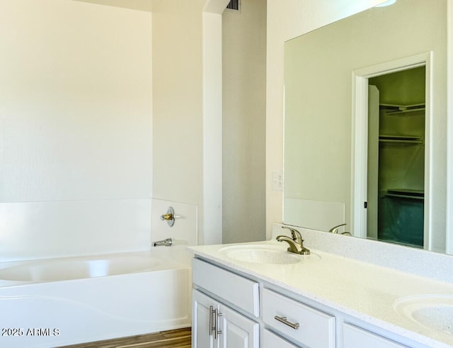 10722 W Quartz Dr, Casa Grande, AZ 85193 - full bath featuring double vanity, a bathtub, and a spacious closet