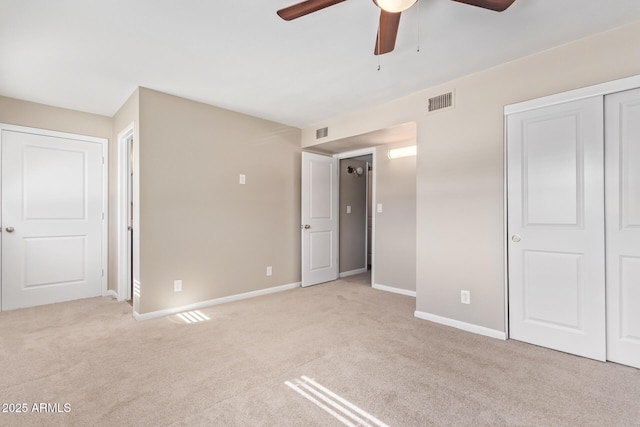 unfurnished bedroom featuring ceiling fan and light colored carpet