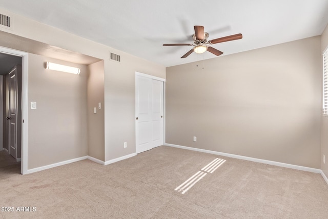 unfurnished room featuring ceiling fan and light colored carpet