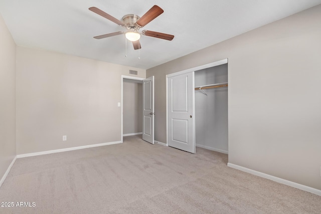 unfurnished bedroom with ceiling fan, a closet, and light colored carpet