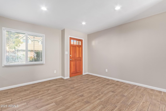 empty room with light hardwood / wood-style floors