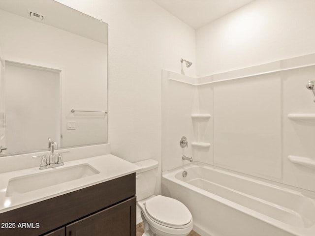 full bathroom featuring vanity, bathtub / shower combination, and toilet