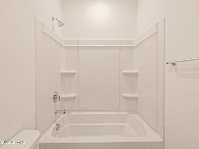 bathroom with toilet and tub / shower combination