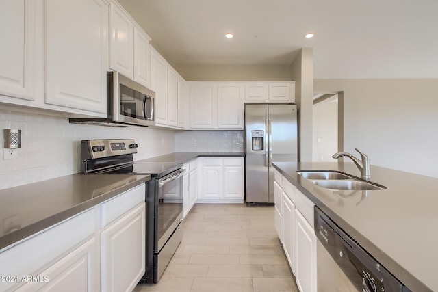 kitchen featuring white cabinets, sink, and appliances with stainless steel finishes