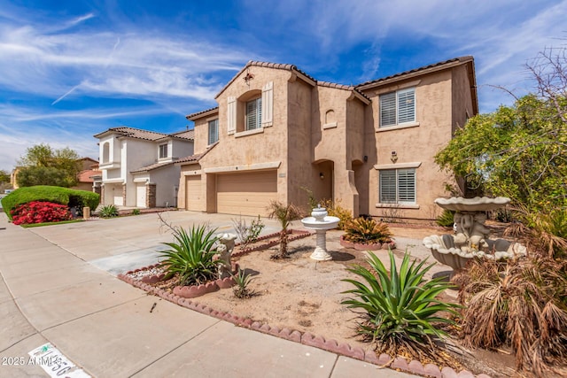 mediterranean / spanish house with stucco siding, driveway, a tile roof, and a garage