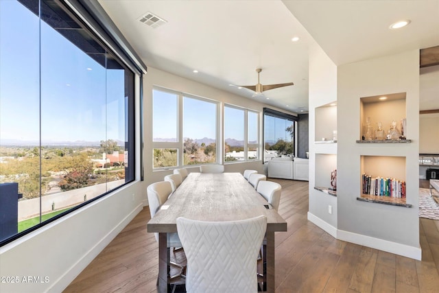 dining space featuring ceiling fan and wood-type flooring