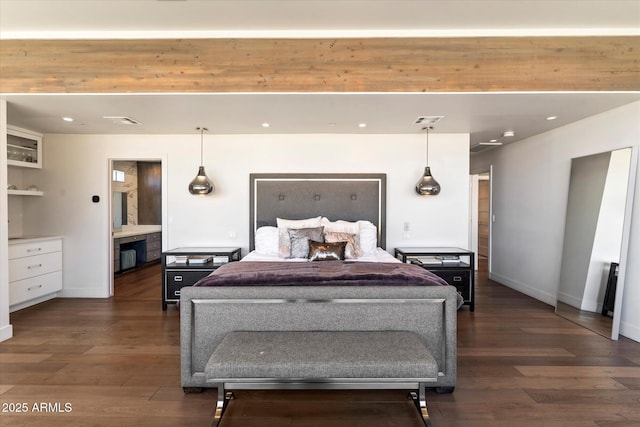 bedroom with dark hardwood / wood-style flooring and ensuite bathroom