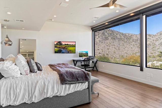 bedroom featuring lofted ceiling, wood-type flooring, and ceiling fan