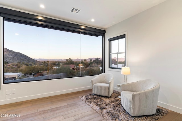 living area with a mountain view and hardwood / wood-style floors