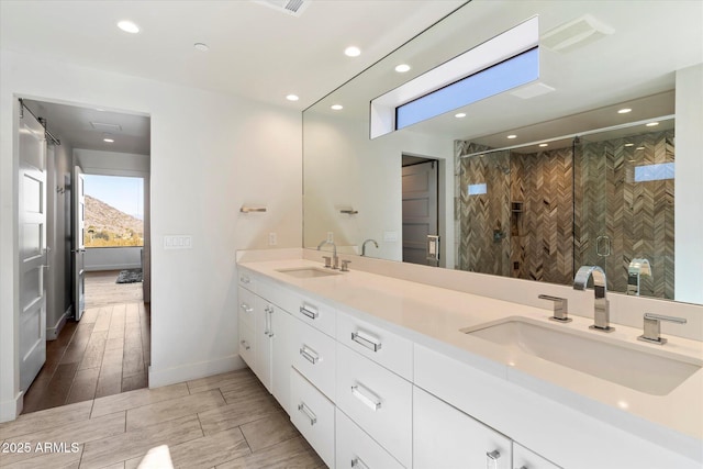 bathroom featuring vanity and an enclosed shower