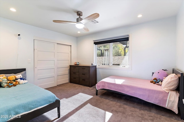 bedroom with ceiling fan, carpet floors, and a closet