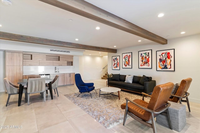 living room featuring beam ceiling and sink