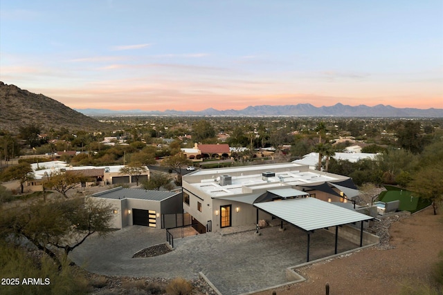 aerial view at dusk featuring a mountain view