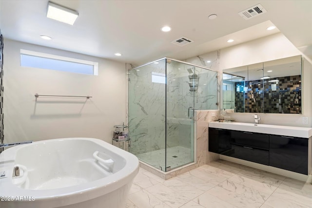 bathroom featuring vanity and independent shower and bath