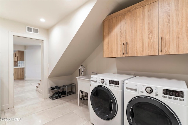 laundry room with independent washer and dryer, sink, cabinets, and light tile patterned floors