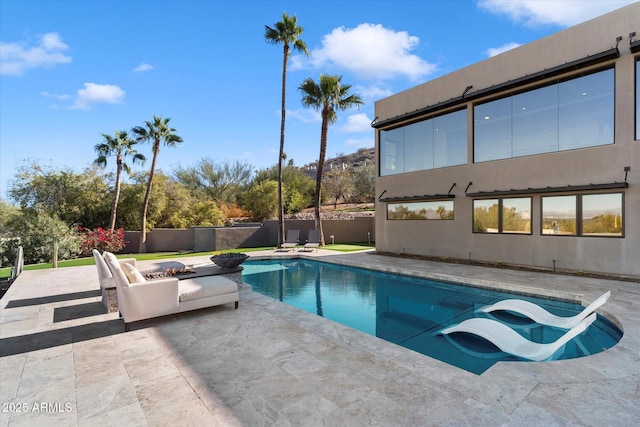 view of swimming pool with a patio area and an outdoor fire pit