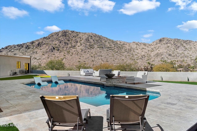 view of pool featuring a grill, a mountain view, and a patio area