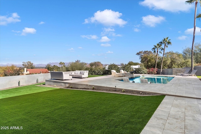 view of pool with outdoor lounge area, a patio area, and a lawn