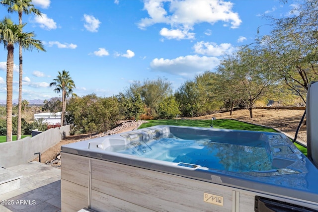 view of swimming pool with a hot tub and a lawn