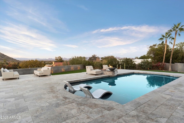 view of swimming pool featuring a patio and a mountain view