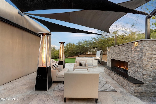 view of patio with an outdoor living space with a fireplace