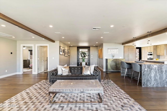 living room featuring beamed ceiling and dark hardwood / wood-style floors