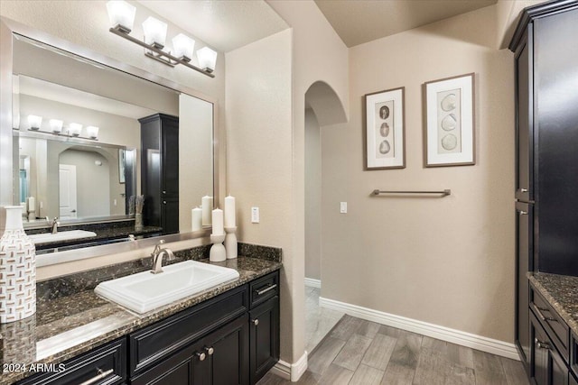 bathroom with vanity and hardwood / wood-style flooring