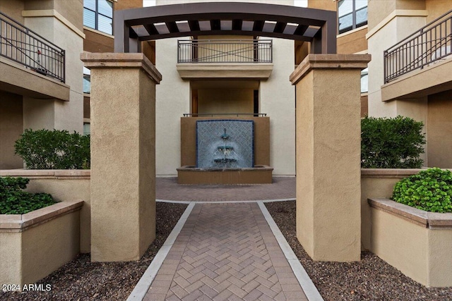 view of exterior entry featuring a balcony