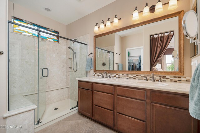 full bathroom featuring a sink, a stall shower, and a healthy amount of sunlight