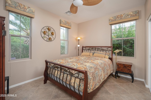 bedroom with visible vents, multiple windows, baseboards, and ceiling fan