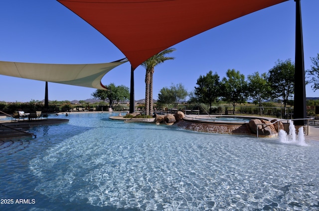 community pool featuring a patio and a community hot tub