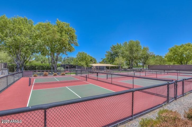 view of sport court featuring fence