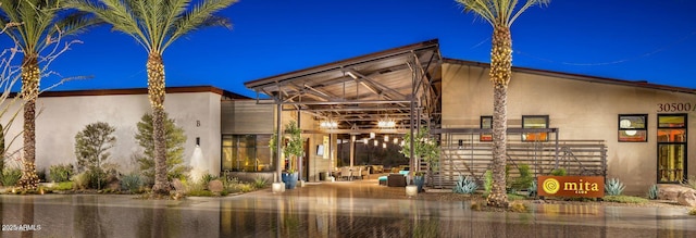 back of property featuring stucco siding