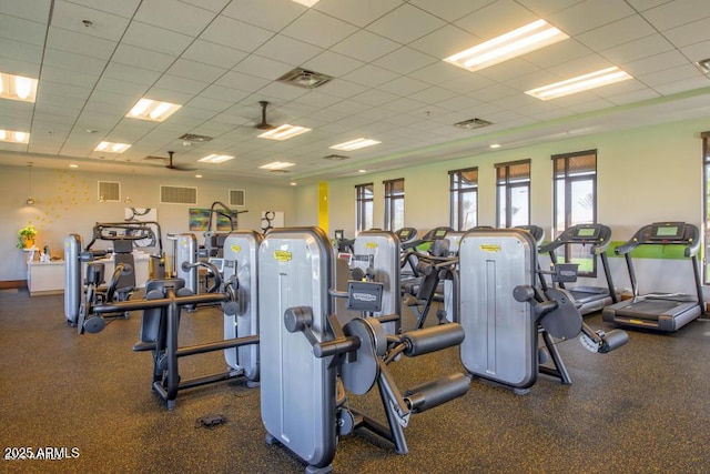 workout area with a drop ceiling and visible vents