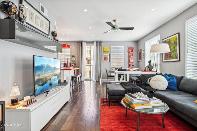 living room featuring ceiling fan and dark wood-type flooring