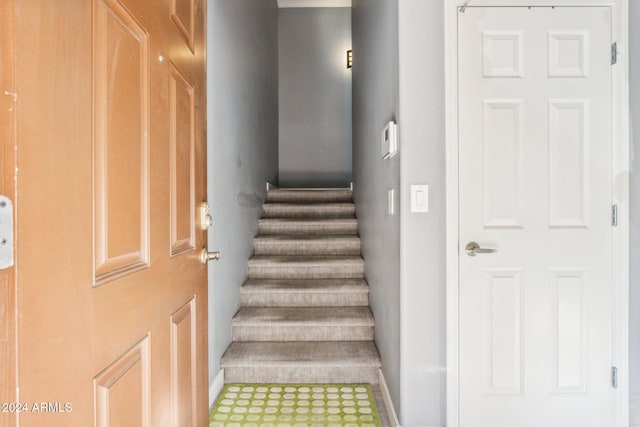 staircase featuring tile patterned flooring