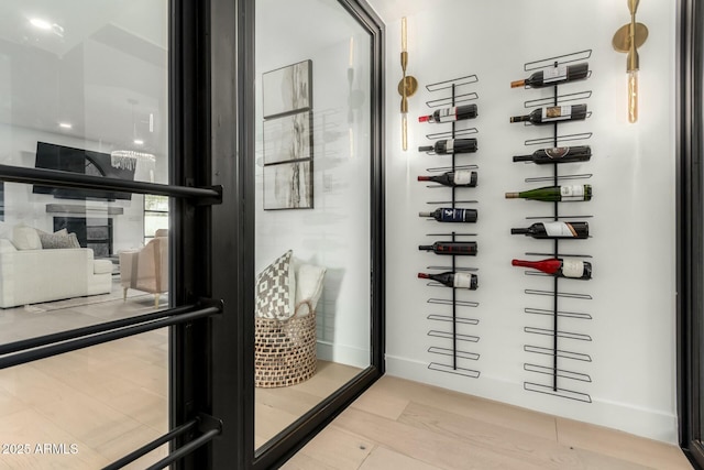 wine room featuring baseboards and wood finished floors