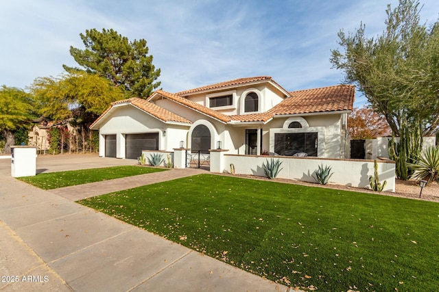 mediterranean / spanish house featuring a fenced front yard, a tile roof, concrete driveway, stucco siding, and an attached garage