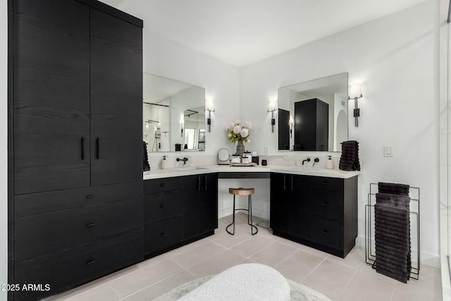 full bath featuring tile patterned flooring, double vanity, and a sink