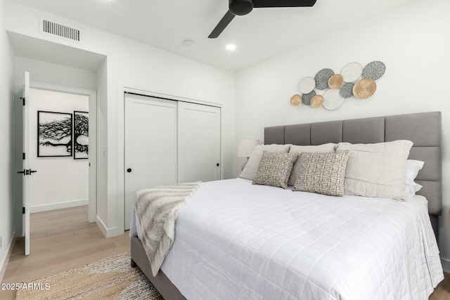 bedroom with visible vents, recessed lighting, a closet, light wood-style floors, and baseboards