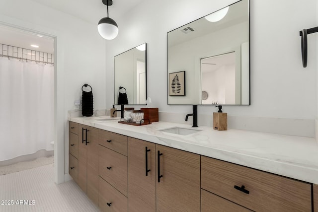 bathroom with double vanity, visible vents, curtained shower, and a sink