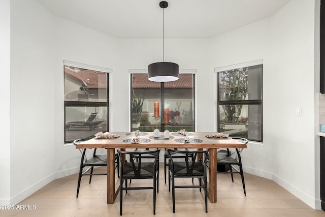 dining space featuring baseboards