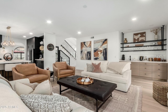 living room featuring a chandelier, visible vents, recessed lighting, and light wood-style floors