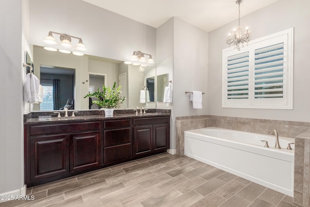 6251 E Bramble Berry Ln, Cave Creek, AZ 85331 - full bath featuring double vanity, a bath, a chandelier, and wood tiled floors