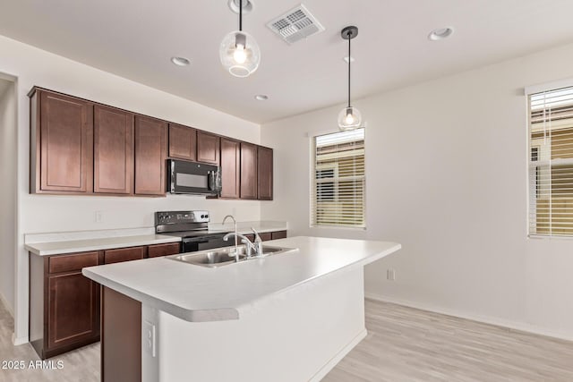 1268 E Jahns Dr, Casa Grande, AZ 85122 - kitchen featuring black microwave, light wood-style flooring, visible vents, and electric range oven